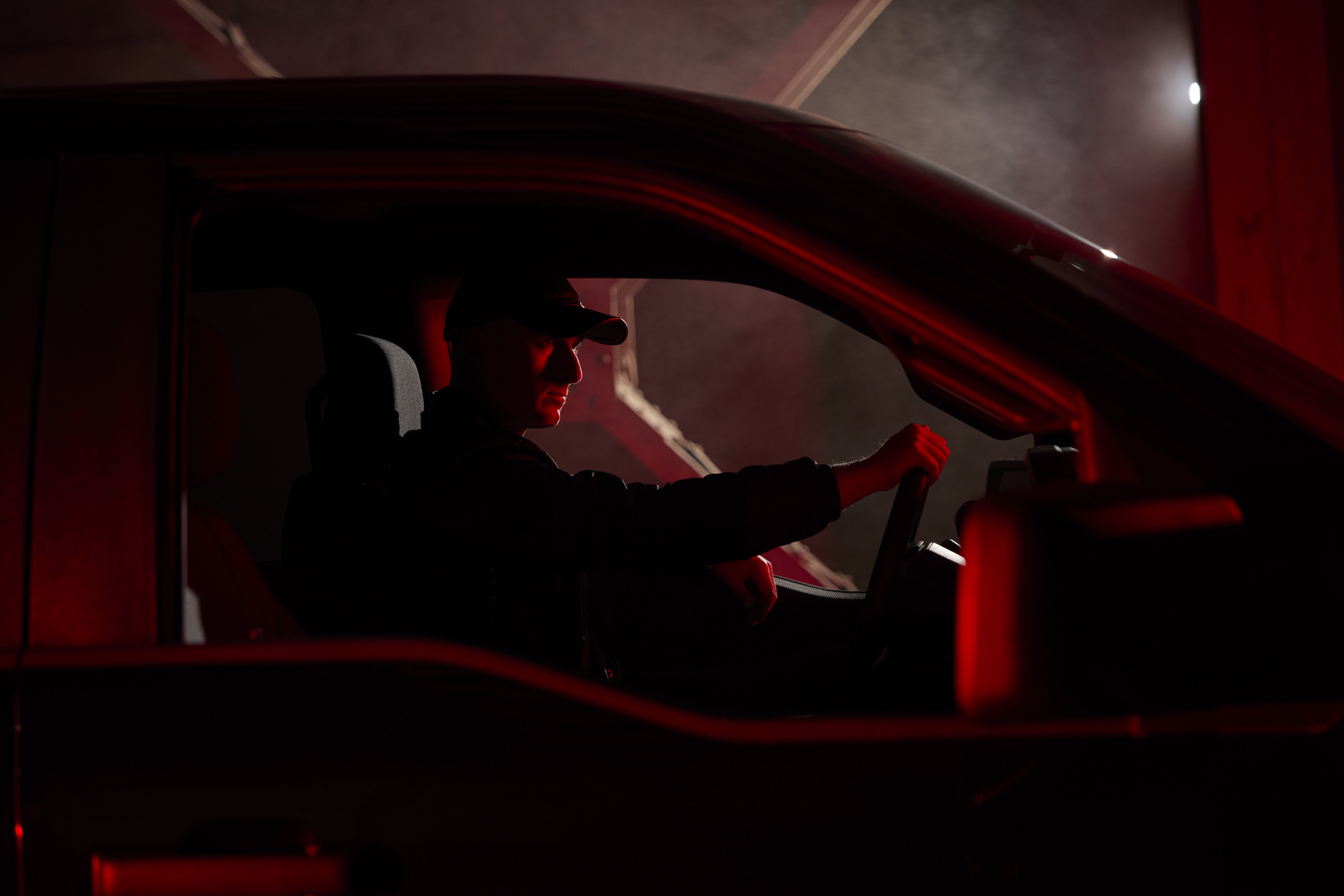 Ford designer Josh Blundo sitting in a 2025 F-150 Lobo. Available Fall 2025.